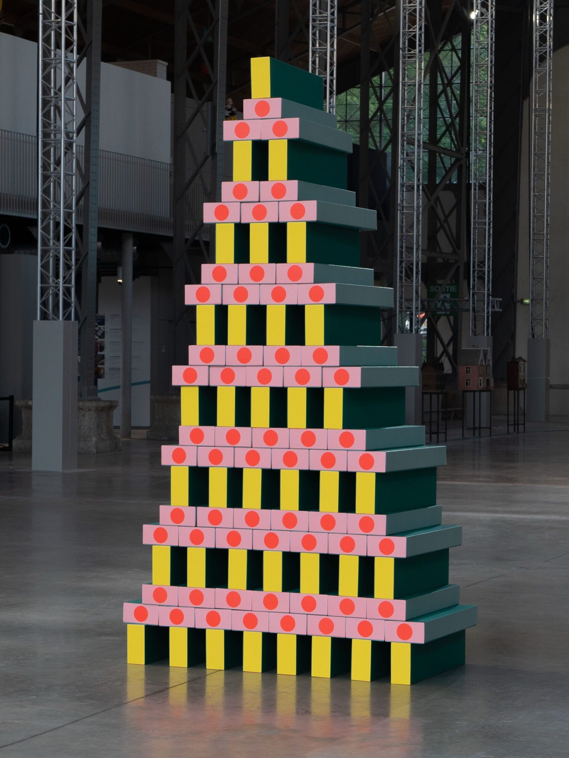 A geometric, colorful, tower-like sculpture by Pinaffo & Pluvinage.